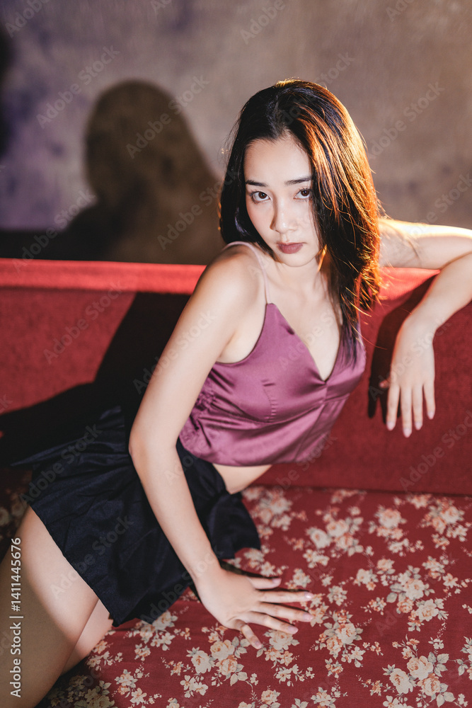 Fototapeta premium Asian model leaning on red shirt in K-pop inspired look