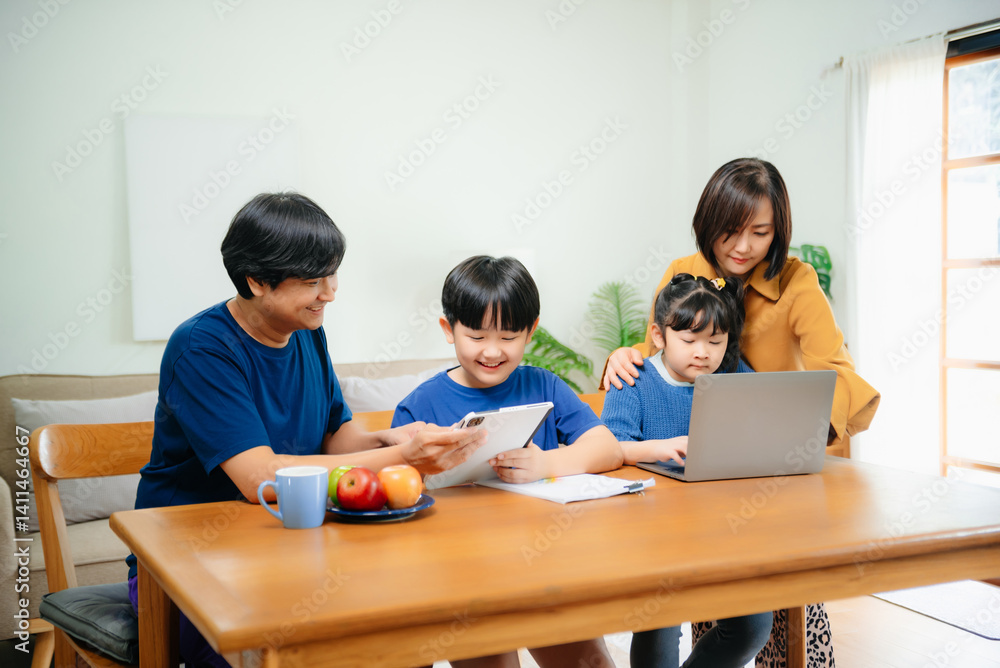 Homeschool Asian young little boy learning online and does homework by using computer and tablet with mother help, teach and encourage. Homeschool Asian young little boy learning online and does homework by using computer and tablet with mother help, teach and encourage.