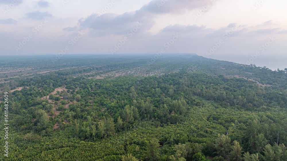 Naklejka premium Aerial view of above Koh Phra Thong Phang Nga Thailand. The lush green forest has white sand beaches around the island and there are small islands. The pristine nature is perfect for relaxation.
