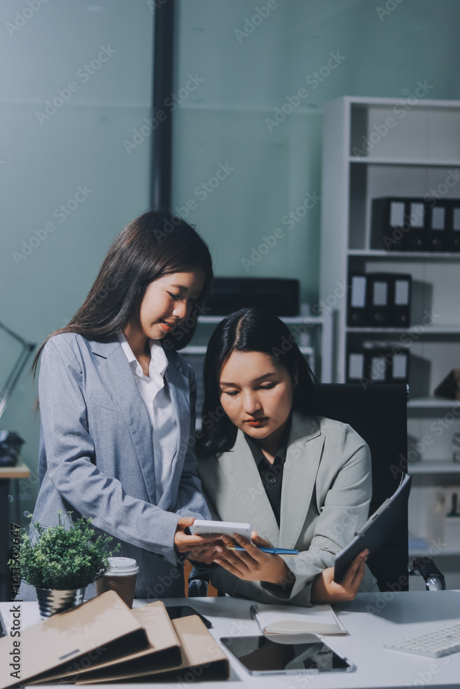 Asian Businesswoman Using laptop computer and working at office with calculator document on desk, doing planning analyzing the financial report, business plan investment, finance analysis concept. Asian Businesswoman Using laptop computer and working at office with calculator document on desk, doing planning analyzing the financial report, business plan investment, finance analysis concept.