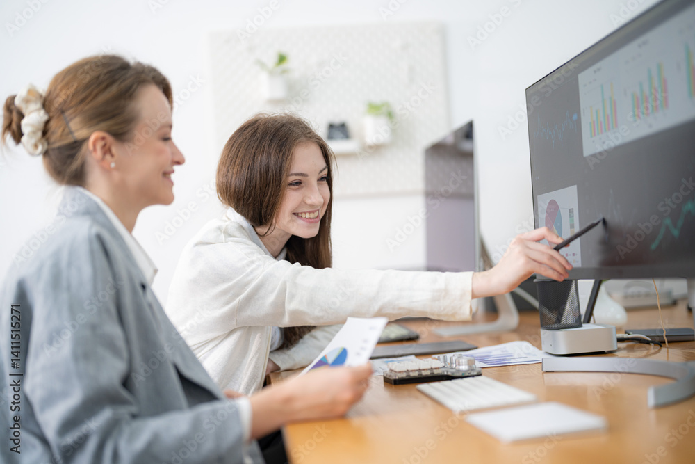 Team members collaborating on data analysis in a modern office environment during work hours Team members collaborating on data analysis in a modern office environment during work hours