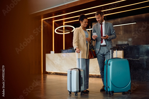 Принти на полотні Happy black businesswoman and her coworker staying in at hotel on their business travel