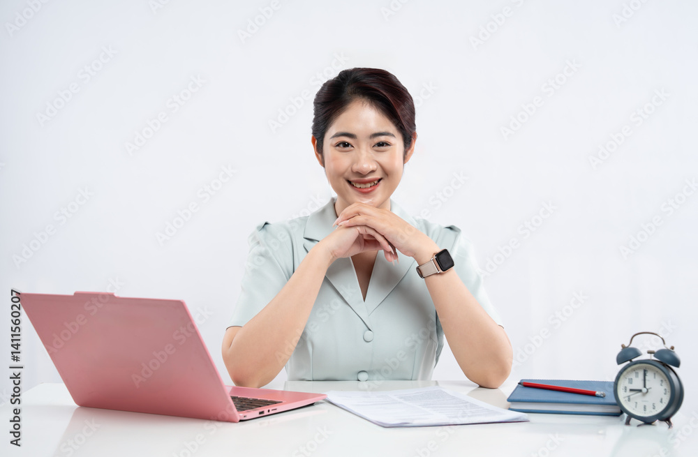 Smiling woman at desk with laptop documents notebook and clock Ready to work and be productive Smiling woman at desk with laptop documents notebook and clock Ready to work and be productive