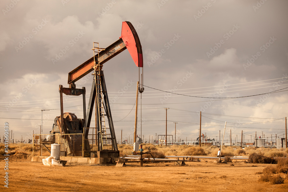 Oil Well Pumpjack Operating in Industrial Field Oil Well Pumpjack Operating in Industrial Field