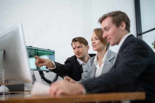 Team collaborating on project analysis in modern office during daytime
