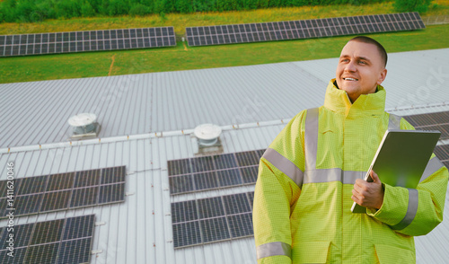 Engineer in reflective jacket near solar panel setup