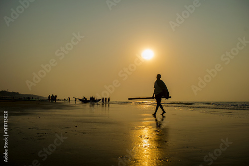 silhouette of a man walking on the beach