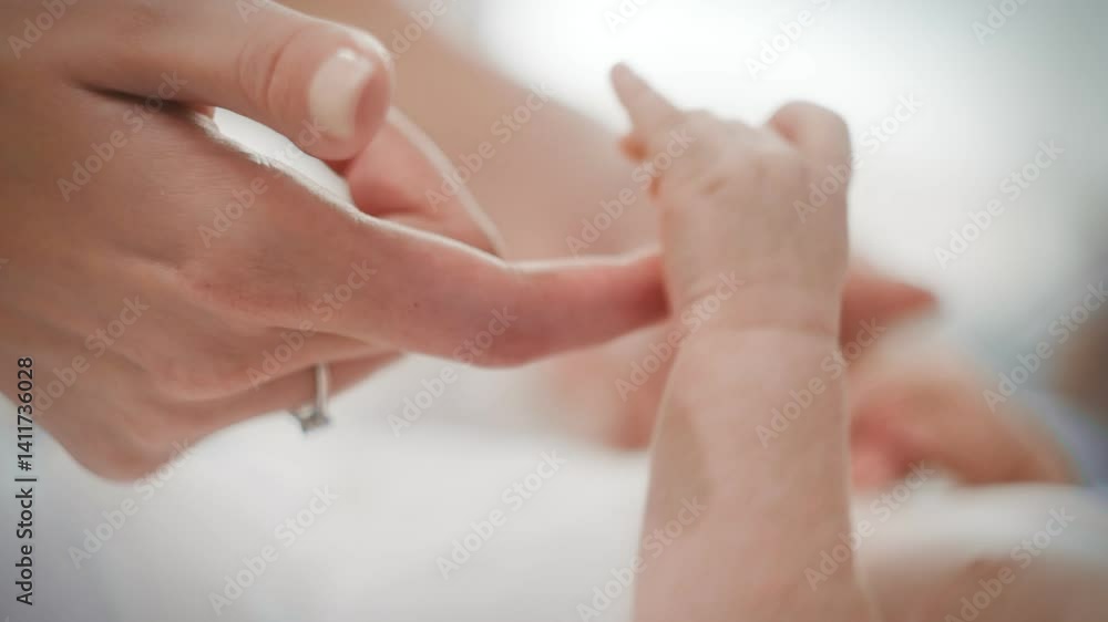 The hand of a small newborn baby touches the mother's hand. The hand of a small newborn baby touches the mother's hand.
