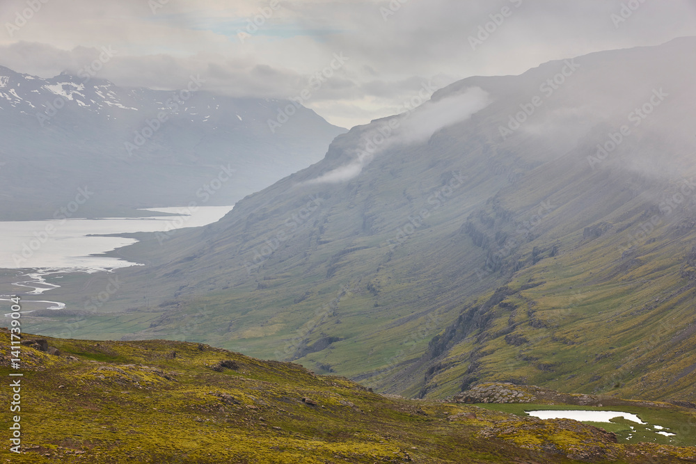 Foggy mountain landscape in Berufjordur fjord. East fjords. Iceland