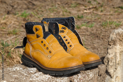 old yellow shoes on a concrete block