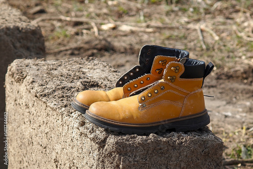 old yellow shoes on a concrete block