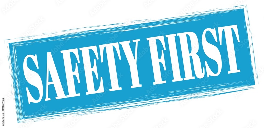 SAFETY FIRST text written on blue stamp sign.
