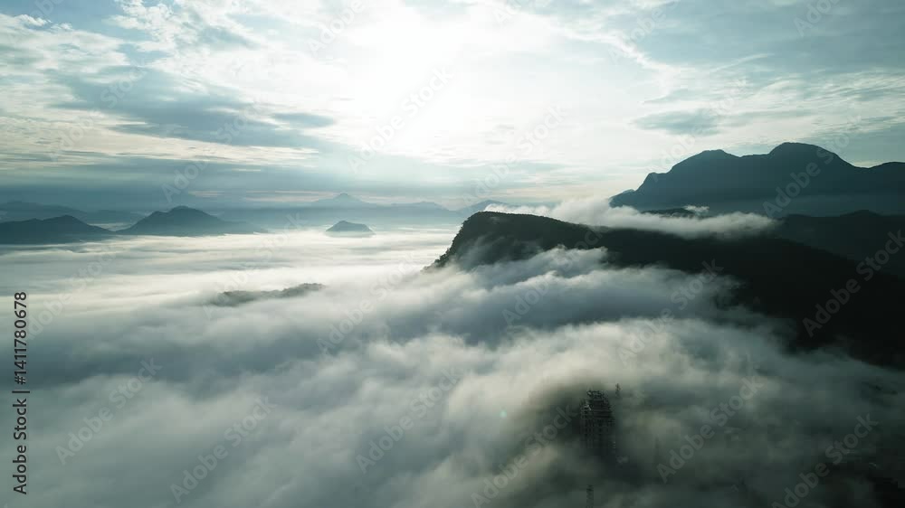Aerial view of cloud covered mountains creating a serene and mystical atmosphere. Aerial view of cloud covered mountains creating a serene and mystical atmosphere.
