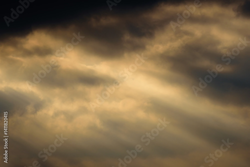 Obraz na płótnie dark dramatic sky at sunset with sun rays through the clouds w salonie