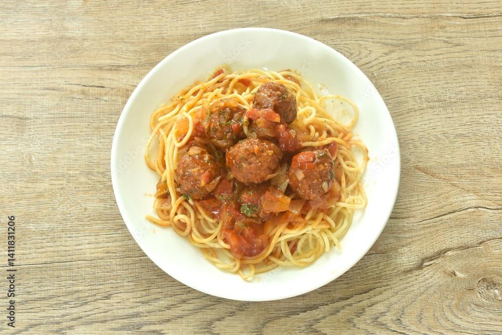 spaghetti dressing fried meatball stuffed cheese in chop onion and tomato ketchup sauce on plate