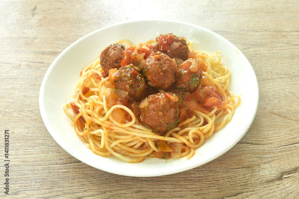 spaghetti dressing fried meatball stuffed cheese in chop onion and tomato ketchup sauce on plate