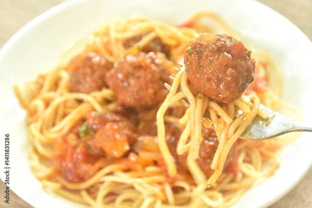 spaghetti dressing fried meatball stuffed cheese in chop onion and tomato ketchup sauce on plate