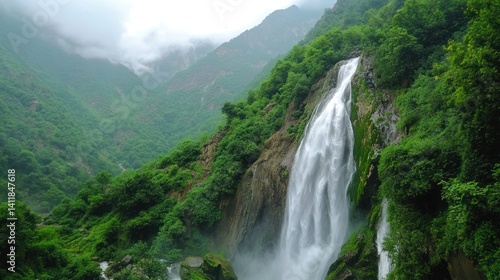 A majestic waterfall cascading down lush green mountain slopes