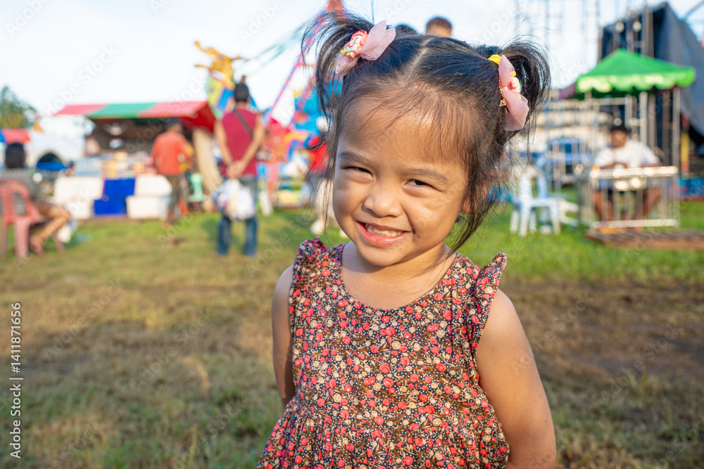 Little girl enjoy outdoor amusement city park festival