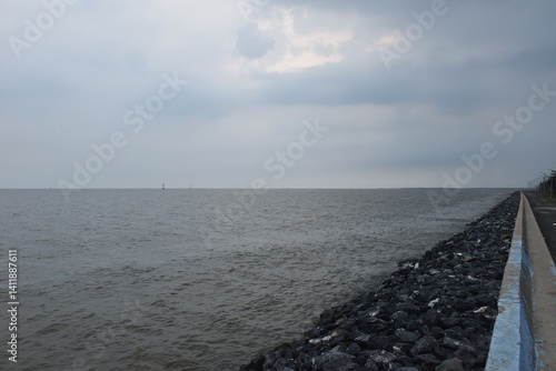 landscape of sea on sunset with rain cloud coming