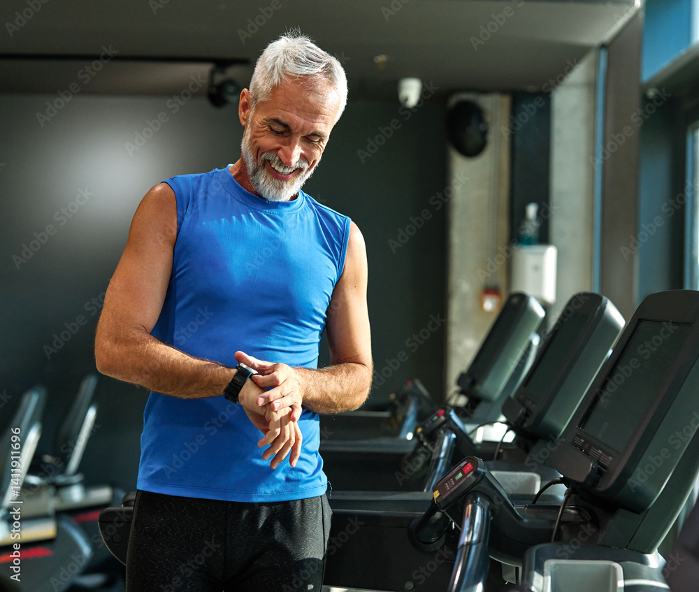 gym sport fitness exercising training mature man running watch smart time smartwatch wristwatch device app checking pulse monitor performance cardio treadmill