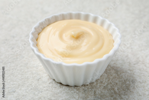 Tasty vanilla pudding on light textured table, closeup
