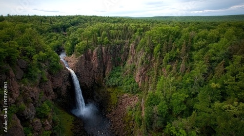 High angle view of waterfall cascading into lush forest