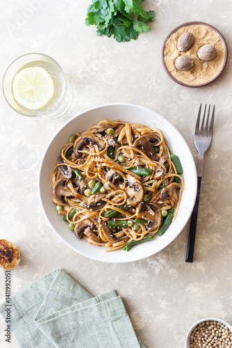Udon noodles in teriyaki sauce with mushrooms, beans and peas. Asian cuisine. Vegetarian food.