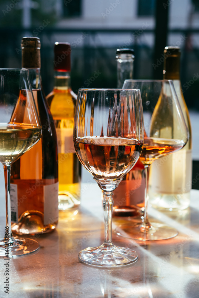 Different types of wine in glasses - red, white, rose and amber. Wine tasting in a bar or restaurant.