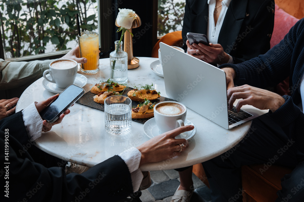 People discussing business projects in a cafe while having coffee.