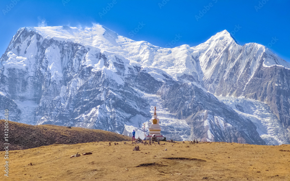 Himalayas, Nepal - The famous hiking on the roof of the world called Annapurna Circuit in the Himalaya range mountain, with little village, buddhist stupa and mountains of 8000 meters.