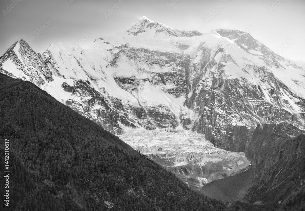 Himalayas, Nepal - The famous hiking on the roof of the world called Annapurna Circuit in the Himalaya range mountain, with little village, buddhist stupa and mountains of 8000 meters.