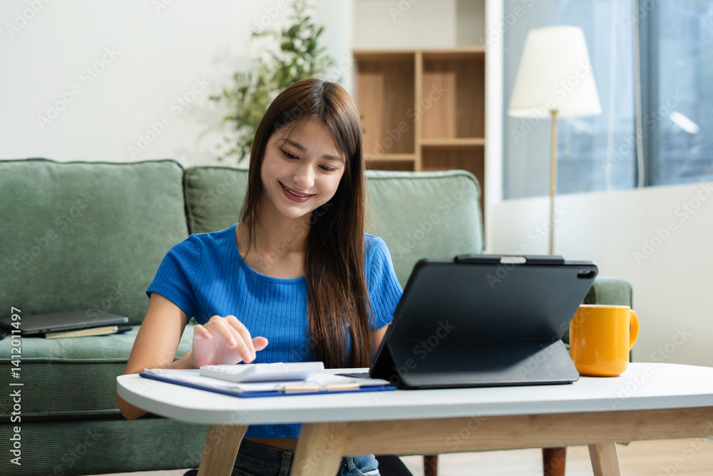 lifestyle of office workers, Woman calculating expenses and using laptop. Home office. Work place. Lifestyle. lifestyle of office workers, Woman calculating expenses and using laptop. Home office. Work place. Lifestyle.