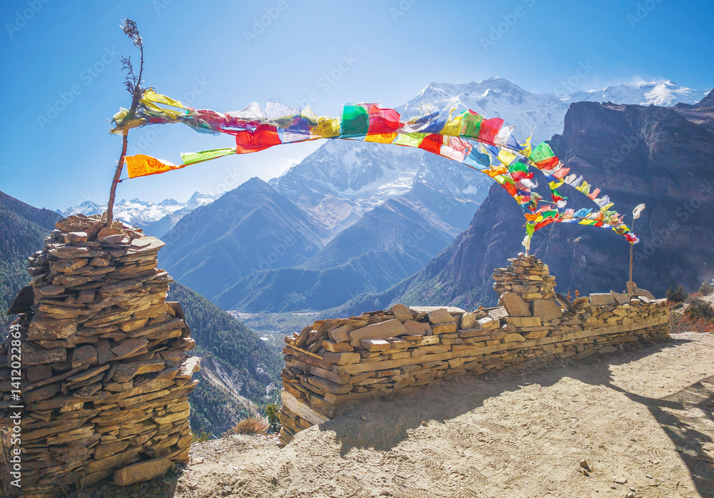Himalayas, Nepal - The famous hiking on the roof of the world called Annapurna Circuit in the Himalaya range mountain, with little village, buddhist stupa and mountains of 8000 meters.
