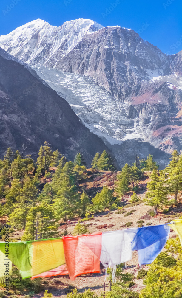 Himalayas, Nepal - The famous hiking on the roof of the world called Annapurna Circuit in the Himalaya range mountain, with little village, buddhist stupa and mountains of 8000 meters.