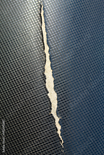 Black motorcycle seat peeling lengthwise