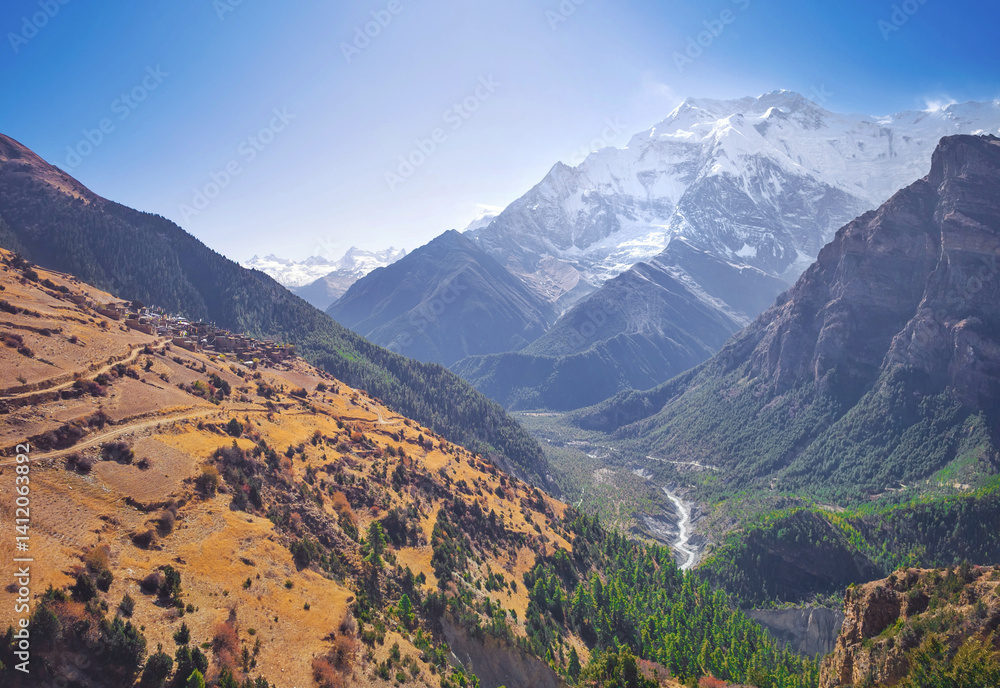Himalayas, Nepal - The famous hiking on the roof of the world called Annapurna Circuit in the Himalaya range mountain, with little village, buddhist stupa and mountains of 8000 meters.