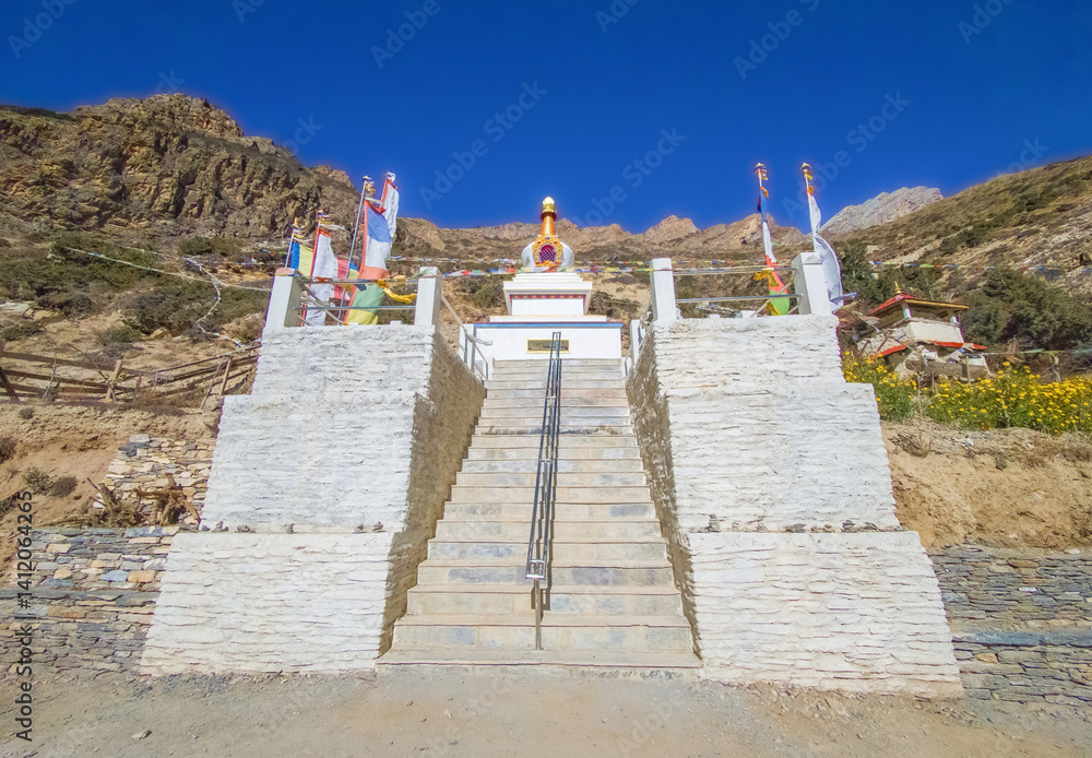 Himalayas, Nepal - The famous hiking on the roof of the world called Annapurna Circuit in the Himalaya range mountain, with little village, buddhist stupa and mountains of 8000 meters.