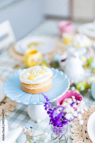 Easter table set up with lemon cake on blue platter