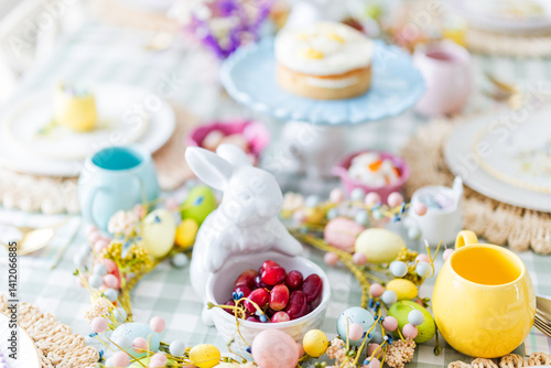 Easter table with bunny statue holding strawberries