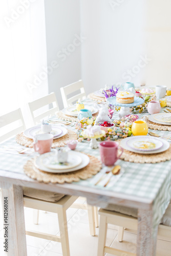 Easter table with pink, blue and yellow settings