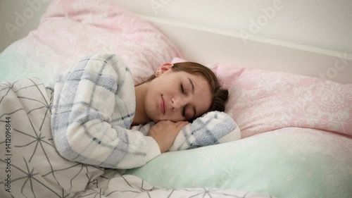Young Girl In Pajamas Sweetly Sleeping In Bed During A Daytime Nap