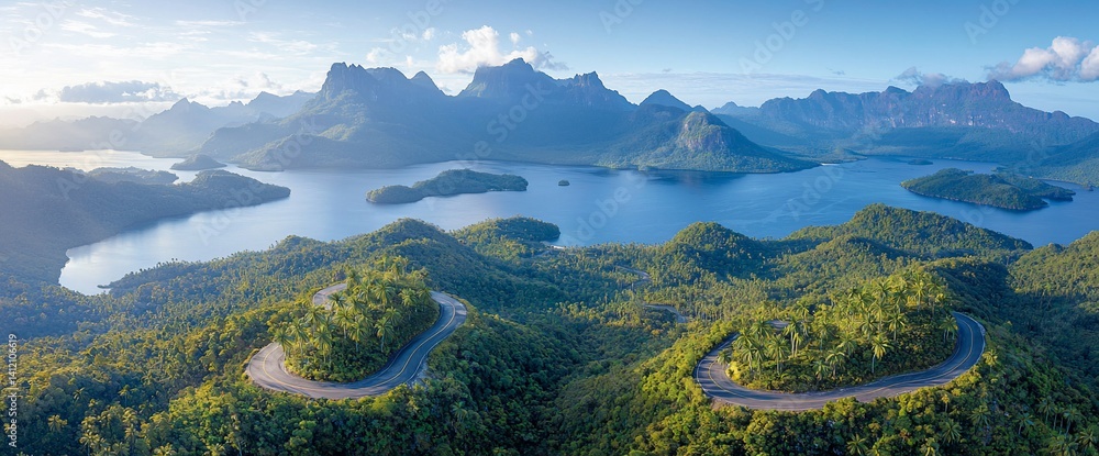 Winding road through lush mountains and serene lake