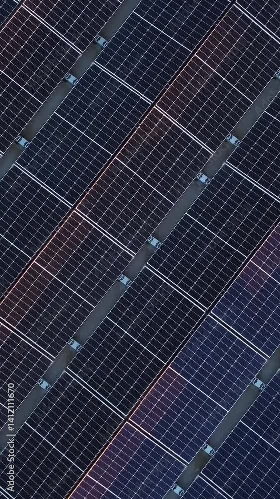 A zoom-out top-down view showcasing the vast area of a large solar panel on a roof. A zoom-out top-down view showcasing the vast area of a large solar panel on a roof.
