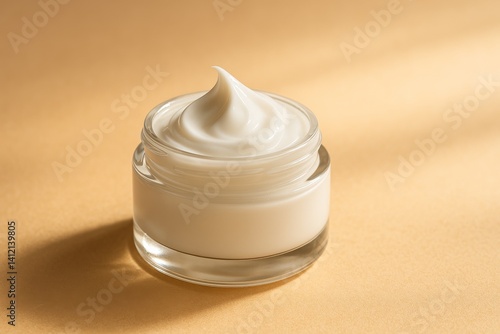 Cream in Clear Container on Peach Surface Highlighting Beauty Products Textur...