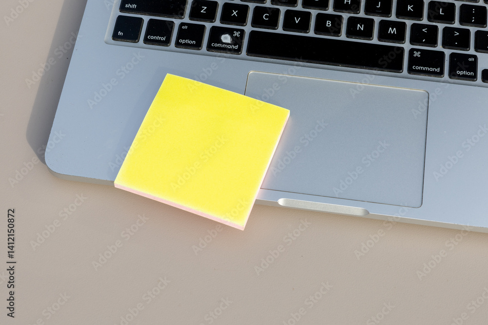 Office Routine: Yellow Note on Laptop Surface for Business Tasks Office Routine: Yellow Note on Laptop Surface for Business Tasks