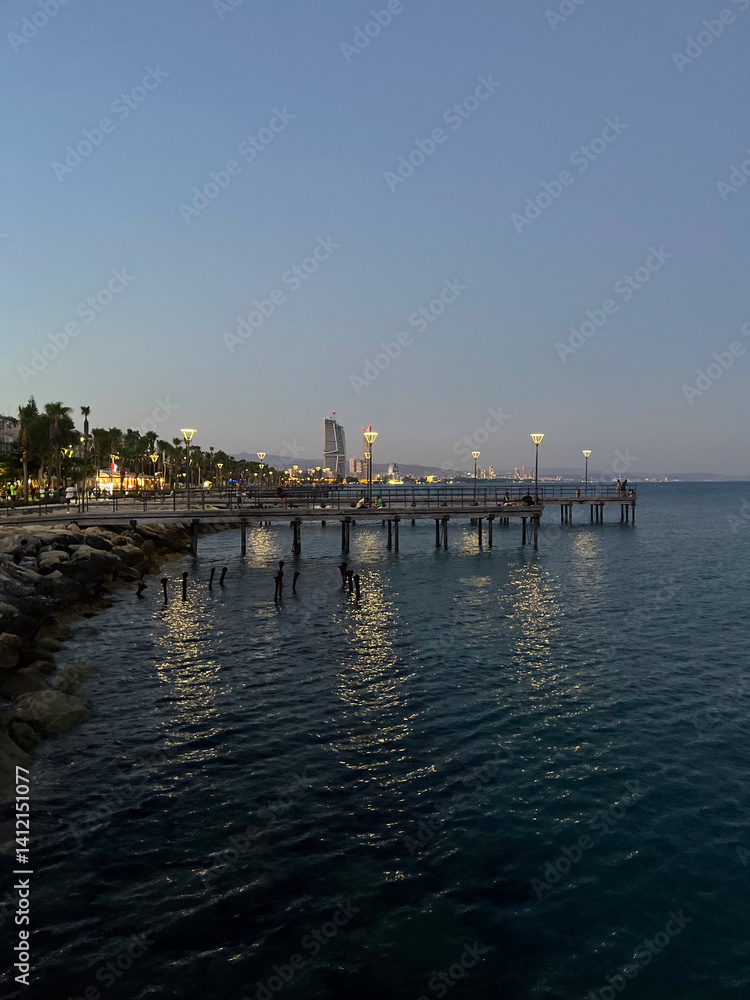 Obraz premium Evening Promenade Lights by the Sea in Cyprus