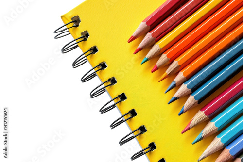 Colorful pencils arranged neatly beside a bright yellow notebook on a clean surface isolated on transparent background
