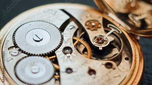 Wallpaper Mural This slow-motion close-up highlights the fine mechanics of a vintage pocket watch, focusing on its intricate gear system. The camera pans from left to right, revealing the precision of the watch. Torontodigital.ca