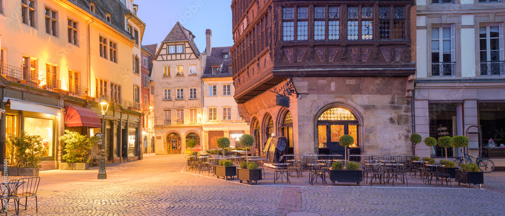 Historic architecture and evening ambiance in Strasbourg's picturesque Cathedral square invite visitors to explore the charm of the city
